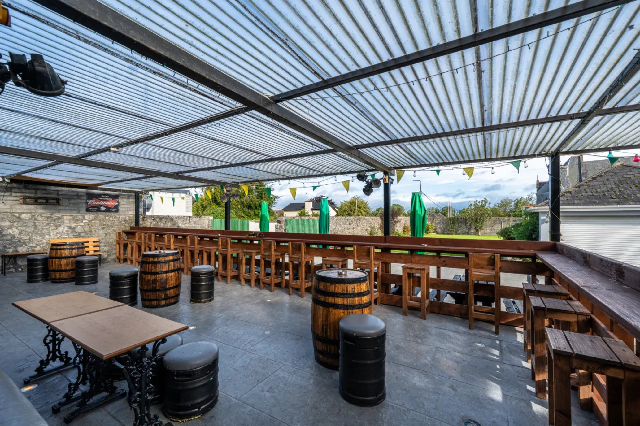 Covered outdoor area with barrel tables
